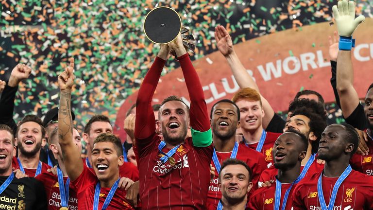 Liverpool captain Jordan Henderson lifts the Club World Cup trophy