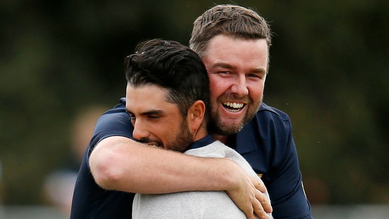 Marc Leishman hugs Abraham Ancer during Saturday's foursomes at the Presidents Cup