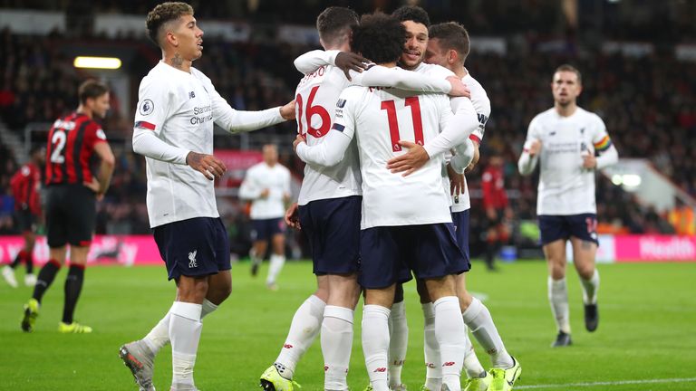 Mohamed Salah celebrates with team-mates after scoring Liverpool's third