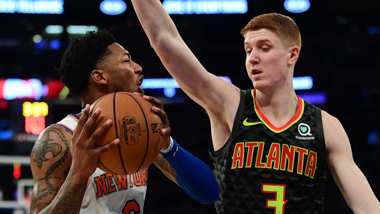Elfrid Payton of the New York Knicks is guarded by Kevin Huerter of the Atlanta Hawks