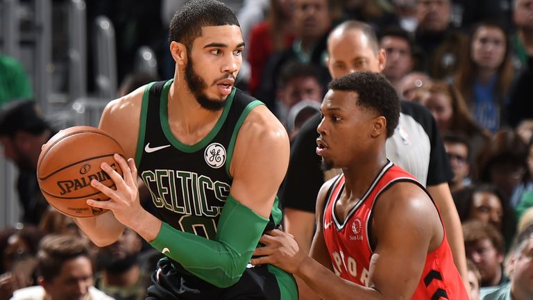Celtics forward Jayson Tatum is defended by Raptors guard Kyle Lowry