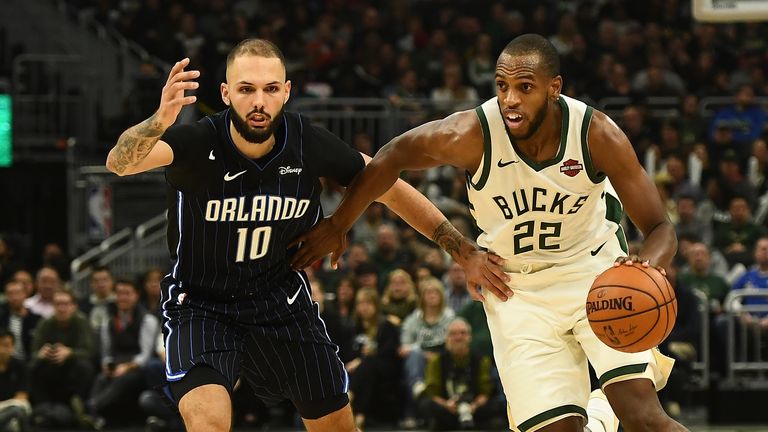 MILWAUKEE, WISCONSIN - DECEMBER 28: Khris Middleton #22 of the Milwaukee Bucks is defended by Evan Fournier #10 of the Orlando Magic during the first half of a game at Fiserv Forum on December 28, 2019 in Milwaukee, Wisconsin. NOTE TO USER: User expressly acknowledges and agrees that, by downloading and or using this photograph, User is consenting to the terms and conditions of the Getty Images License Agreement. (Photo by Stacy Revere/Getty Images)
