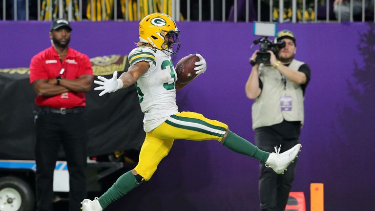 Running back Aaron Jones #33 of the Green Bay Packers rushes for a touchdown in the fourth quarter of the game against the Minnesota Vikings
