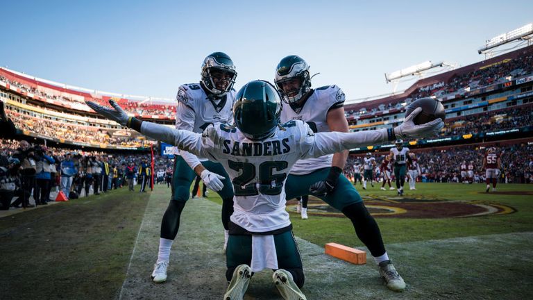 Miles Sanders #26 of the Philadelphia Eagles celebrates with J.J. Arcega-Whiteside #19 and Dallas Goedert #88 after catching a pass for a touchdown against the Washington Redskins