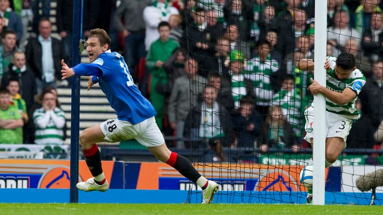 Nikica Jelavic (left) wheels away to celebrate in 2011 as his shot finally creeps over the line despite the efforts of Celtic's Emilio Izaguirre