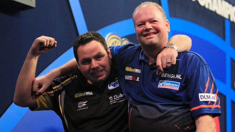 Adrian Lewis is congratulated by Raymond van Barneveld for hitting a nine-darter during the pair's third round meeting in 2015