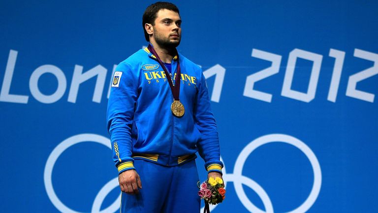 Silver medalist Navab Nasirshelal of Islamic Republic of Iran, gold medalist Oleksiy Torokhtiy of Ukraine and bronze medalist Bartlomiej Wojciech Bonk of Poland pose on the podium during the medal ceremony for the Men's 105kg Weightlifting on Day 10 of the London 2012 Olympic Games at ExCeL on August 6, 2012 in London, England. (