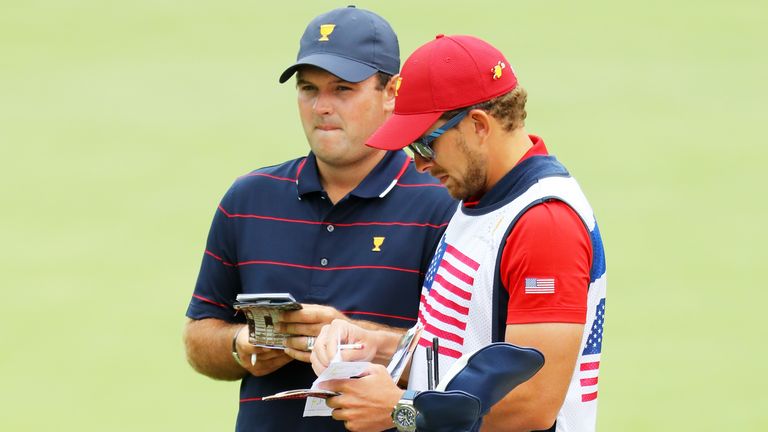 Patrick Reed of the United States team talks with his caddie Kessler Karain at the Presidents Cup