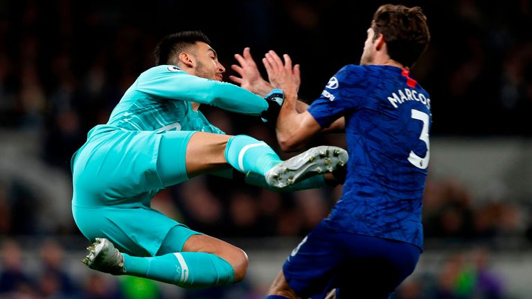 Tottenham Hotspur's Argentinian goalkeeper Paulo Gazzaniga (L) gives away a penalty for this challenge on Chelsea's Spanish defender Marcos Alonso (R) during the English Premier League football match between Tottenham Hotspur and Chelsea at Tottenham Hotspur Stadium in London, on December 22, 2019.