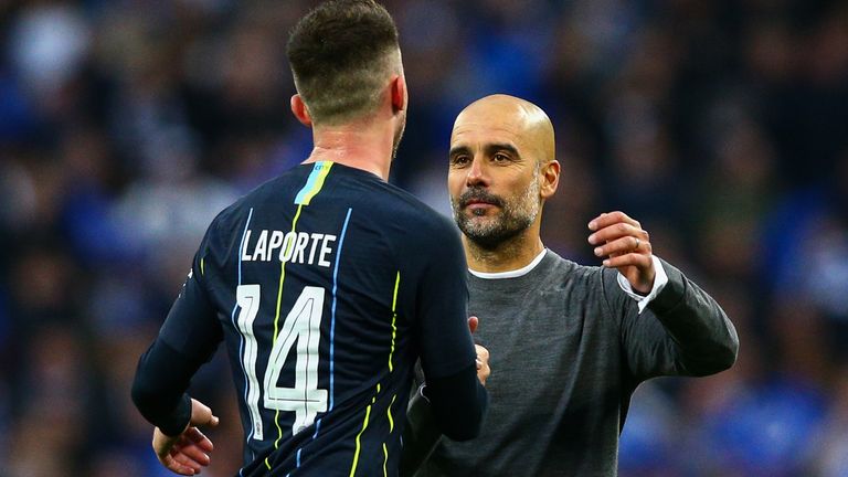 Manchester City manager Pep Guardiola celebrates with Aymeric Laporte after the FA Cup semi-final against Brighton 
