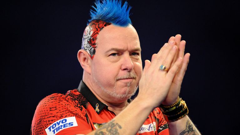 Peter Wright of Scotland applauds fans as he arrives on the stage prior to his Quarter-Final match against Luke Humphries of England during Day Fourteen of the 2020 William Hill World Darts Championship at Alexandra Palace on December 29, 2019 in London, England