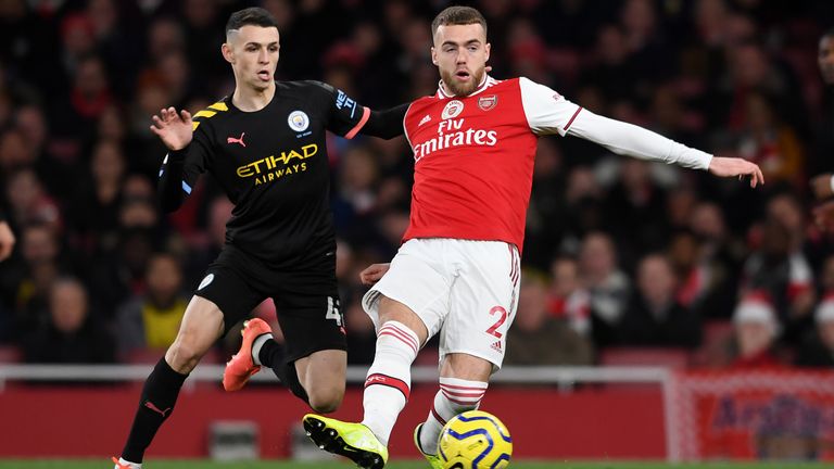 Phil Foden and Calum Chambers during the game between Manchester City and Arsenal in December 2019