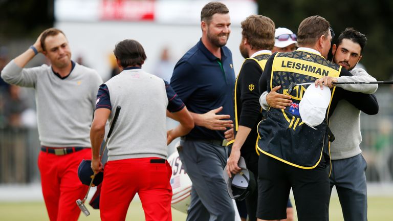 Marc Leishman of Australia and the International team and Abraham Ancer of Mexico and the International team celebrate after halving their match against Justin Thomas of the United States team and Rickie Fowler of the United States team during Saturday afternoon foursomes matches on day three of the 2019 Presidents Cup at Royal Melbourne Golf Course 