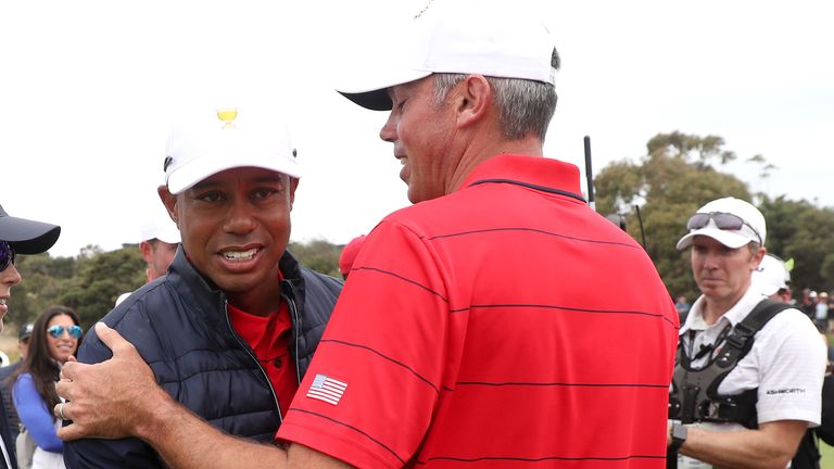 Tiger Woods embraces Matt Kuchar after he secured the USA's victory in the Presidents Cup 