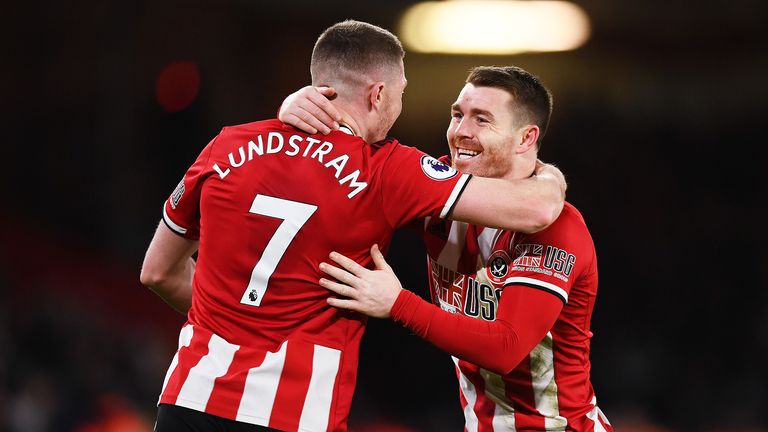 John Fleck of Sheffield United celebrates with teammate John Lundstram after scoring his team's second goal during the Premier League match between Sheffield United and Aston Villa at Bramall Lane on December 14, 2019 in Sheffield, United Kingdom.