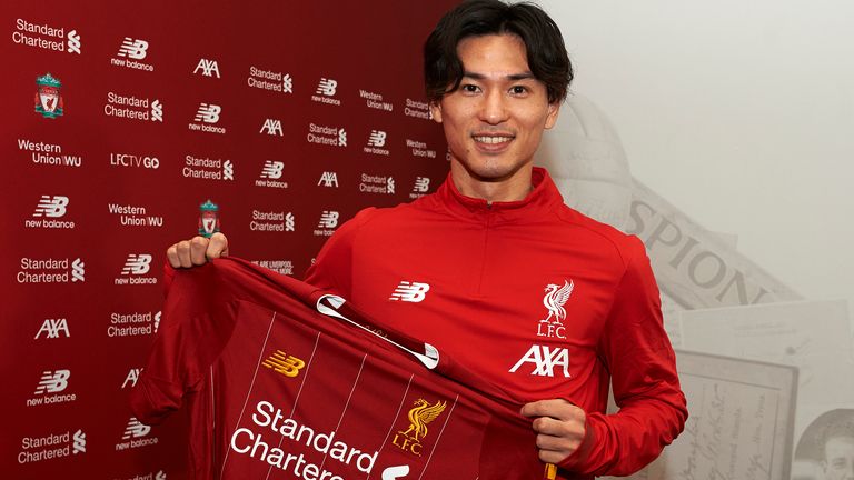 Takumi Minamino pictured with a Liverpool shirt after signing from Red Bull Salzburg