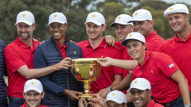 US team captain Tiger Woods (top row, 2nd L) and his teammates pose with the Presidents Cup after their win over the International Team on the final day of the Presidents Cup golf tournament in Melbourne on December 15, 2019