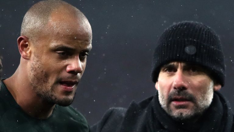 Manchester City manager Pep Guardiola (right) with Vincent Kompany