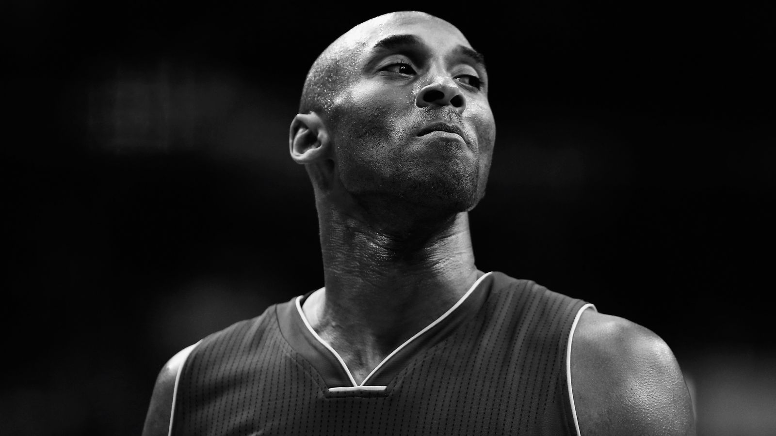 black and white photo of kobe sitting holding a basketball photographed  from the side kobe wallpaper