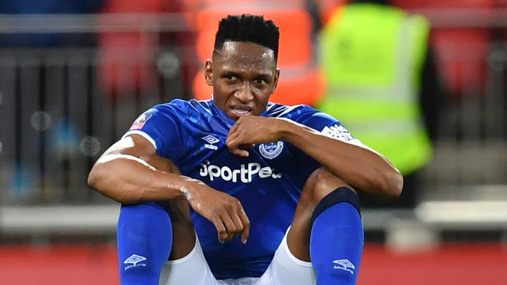 Yerry Mina slumps to the ground at the full-time whistle at Anfield