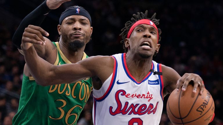 Marcus Smart challenges Josh Richardson as the Sixers forward drives to the basket