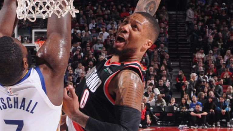 Damian Lillard soars to the rim for a dunk against Golden State