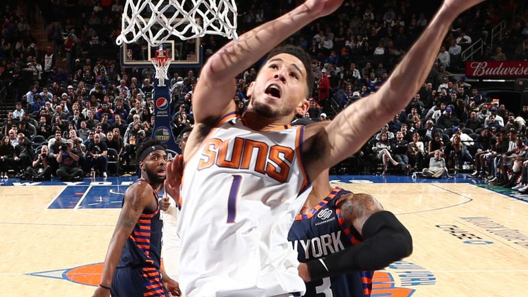 Devin Booker elevates to the rim to score against the New York Knicks