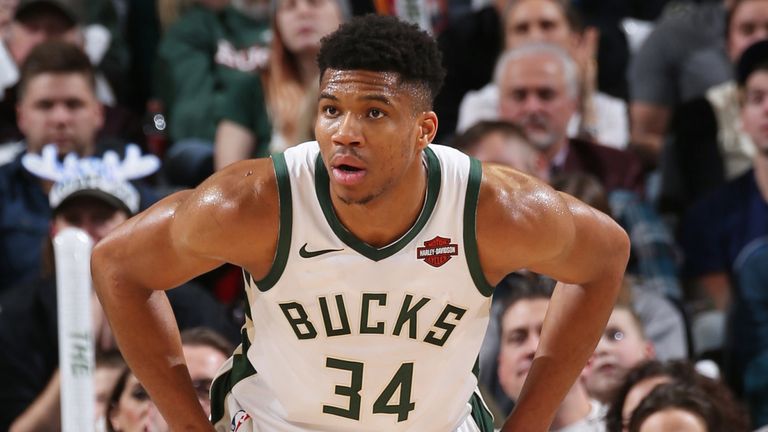 Giannis Antetokounmpo sets himself to play defense against the Timberwolves