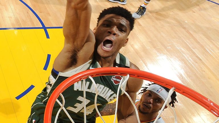 Giannis Antetokounmpo scores with a dunk against Golden State