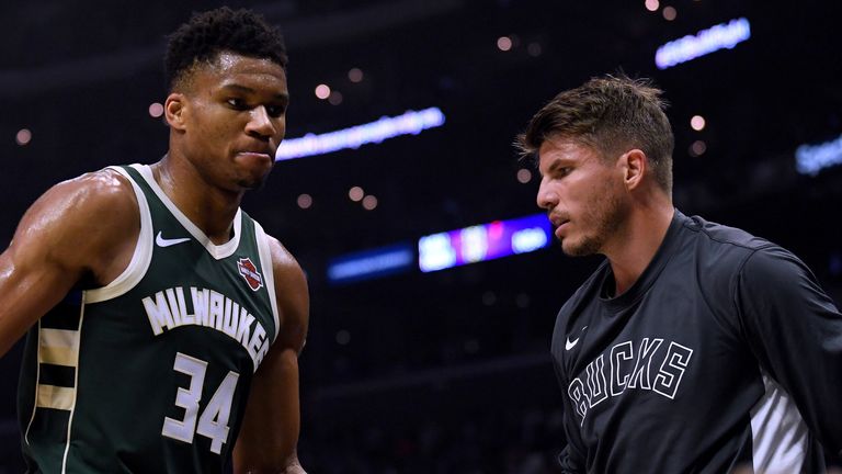 Giannis Antetokounmpo high-fives Bucks team-mate Kyle Korver