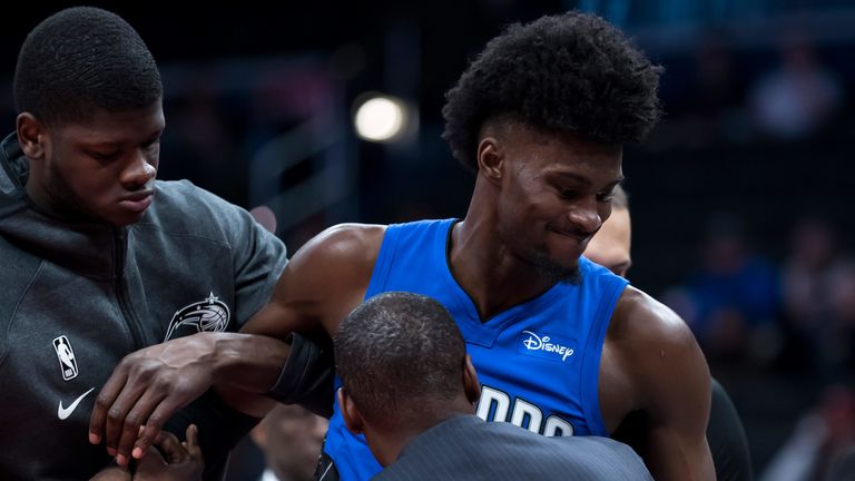 An injured Jonathan Isaac is helped from the court