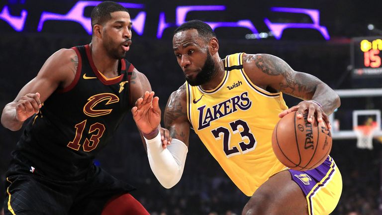 LeBron James drives by former team-mate Tristan Thompson