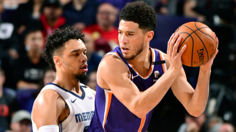 Devin Booker works in the post against Memphis