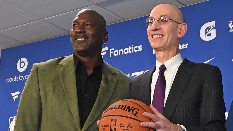 Michael Jordan and Adam Silver pose for photographers at a press conference before the NBA Paris Game