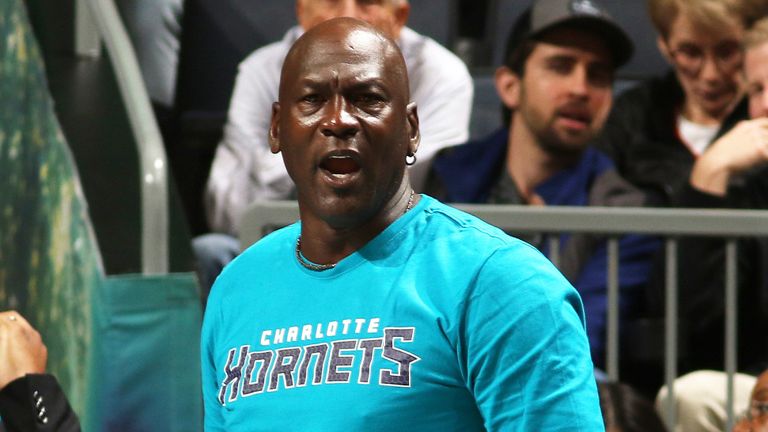 Charlotte Hornets owner Michael Jordan encourages his players from the bench
