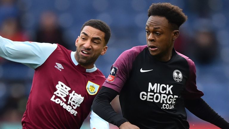 Ricky Jade-Jones of Peterborough United battles for possession with Aaron Lennon of Burnley during the FA Cup Third Round match at Turf Moor