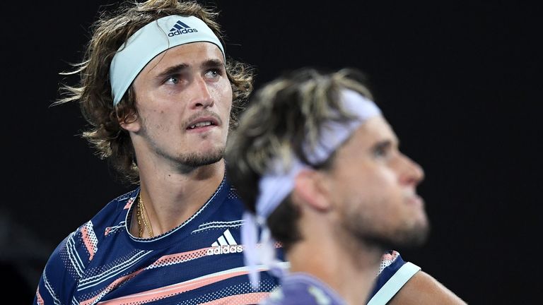 Alexander Zverev of Germany and Dominic Thiem of Austria wait during a delay in play due to the arena lighting during the Men's Singles Semifinal match on day twelve of the 2020 Australian Open at Melbourne Park on January 31, 2020 in Melbourne, Australia