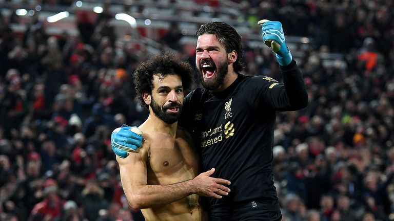 Alisson Becker and Mohamed Salah of Liverpool celebrate victory after the Premier League match between Liverpool FC and Manchester United at Anfield on January 19, 2020 in Liverpool, United Kingdom