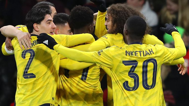 Arsenal players celebrate Bukayo Saka's early goal at Bournemouth