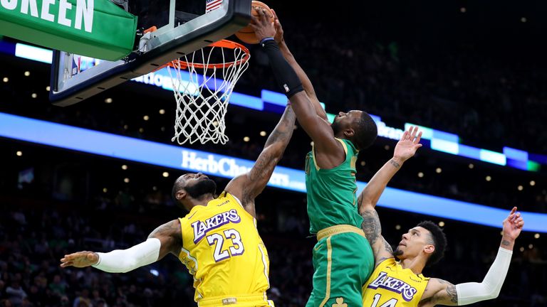 Jaylen Brown of the Boston Celtics dunks over Lebron James
