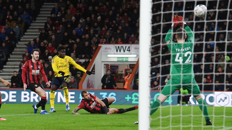 Saka fires the ball past goalkeeper Mark Travers