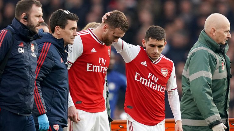 Arsenal's Calum Chambers leaves the game after picking up a knee injury