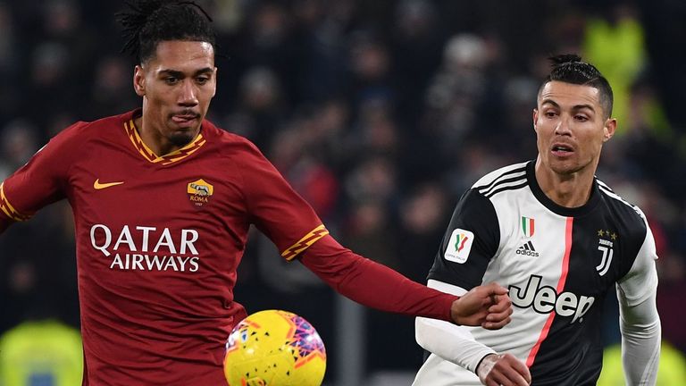 Roma's Chris Smalling and Juventus' Cristiano Ronaldo go for the ball during the Coppa Italia round of eight