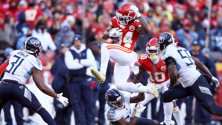 Darwin Thompson of the Kansas City Chiefs runs with the ball and jumps over Adoree&#39; Jackson of the Tennessee Titans in the second half in the AFC Championship Game