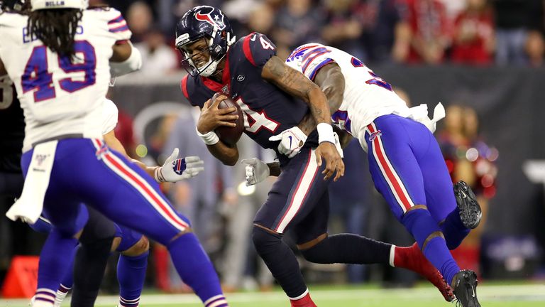 Deshaun Watson of the Houston Texans avoids the sack attempt from Siran Neal of the Buffalo Bills during overtime of the AFC Wild Card Playoff game 
