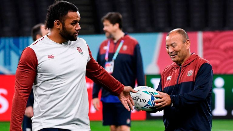 England's coach Eddie Jones (R) receives the ball from flanker Billy Vunipola (L) during the team's Captain's Run in Sapporo on September 20, 2019, ahead of the Japan 2019 Rugby World Cup. 