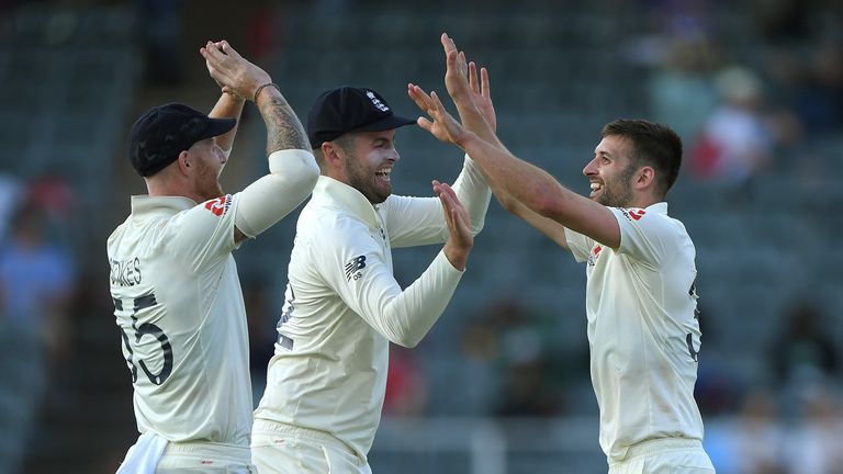 England bowler Mark Wood celebrates with Dom Sibley and Ben Stokes (l) after dismissing Anrich Nortje during Day Two of the Fourth Test between South Africa and England at Wanderers on January 25, 2020 in Johannesburg, South Africa.