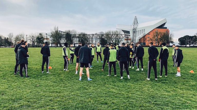 Anfield's main stand looms in the background as Sheffield United train in Stanley Park