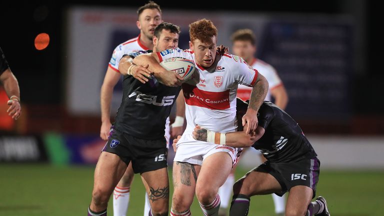 Hull KR&#39;s Harvey Livett is tackled by Wakefield&#39;s Danny Brough and Jay Pitt 
