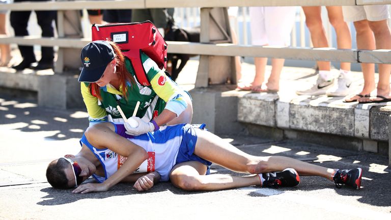 GOLD COAST, AUSTRALIA - APRIL 15: Callum Hawkins of Scotland is given assistance as he collapses in the Men's marathon on day 11 of the Gold Coast 2018 Commonwealth Games at Southport Broadwater Parklands on April 15, 2018 on the Gold Coast, Australia. (Photo by Cameron Spencer/Getty Images)